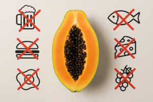Central papaya image surrounded by six food icons marked with red X symbols to show incompatible pairings.